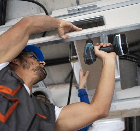 low-angle-people-working-with-drill